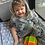 toddler, child, smiling, hooded_robe, blanket, playpen, toy, colorful, indoor, happy, feet, curly_hair, padded_floor, fabric, polka_dot, soft_toys, baby, cute, infant, play