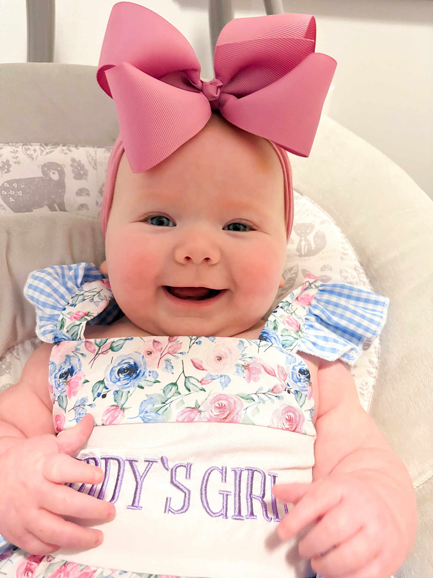 Sinclair joined the competition — help win amazing prizes! baby, child, smiling, pink_bow, floral_dress, daddys_girl, cushioned_chair, infant, cute, happy, portrait, indoors, headband, person, baby_clothes, baby_girl, close_up, cheerful, seated, plush
