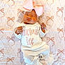 Sinclair is registered to the contest to win money with this photo: baby, child, cute, fabric, headband, indoors, infant, lying_down, newborn, pastel_colors, patterned_background, peaceful, pink_bow, portrait, quilt, sleeping, small_hands, soft_lighting, text_on_clothing, white_outfit