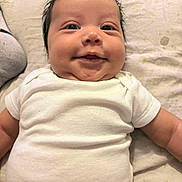 Saint joined the competition — help win amazing prizes! baby, infant, smile, white_onesie, chubby_cheeks, lying_down, blanket, soft_texture, cute, happy, person, indoors, child, face, head, skin, hair, expression, newborn, closeup