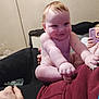 Reginald is registered to the contest to win money with this photo: baby, child, smiling, indoor, person, hand, lap, tablet, clothing, sitting, face, skin, hair, adult, furniture, room, radiator, casual, relaxed, cozy