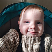 Reginald joined the competition — help win amazing prizes! baby, child, smiling, blue_eyes, knit_sweater, cozy, portrait, close_up, indoor, seat, car_seat, child_seat, cute, happy, face, infant, young_child, warm_light, soft_texture, casual_clothing