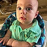 Carson joined the competition — help win amazing prizes! baby, carpet, child, clothing, curious, cute, expression, face, food_smudge, frog_pattern, furniture, green_shirt, hands, high_chair, indoor, infant, person, portrait, seated, wide_eyes