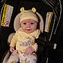 Kaycen is registered to the contest to win money with this photo: baby, infant, car_seat, yellow_hat, pajamas, cartoon_characters, safety_straps, smile, child, cute, indoors, seat, clothing, person, headwear, young_child, warning_labels, baby_clothes, sitting, portrait