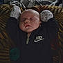baby, blanket, child, clothing, cozy, cute, face, hands_up, head, indoor, infant, mittens, nike, peaceful, portrait, rest, sleeping, soft_lighting, young, zipped_jacket