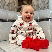 Aëly participe au concours pour gagner de l'argent avec cette photo : baby, infant, child, smiling, laughing, sitting, red_socks, onesie, minnie_mouse, tuft_hair, earrings, cute, portrait, indoor, chair, cushion, plastic_cover, playful, happy, closeup