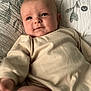 Remi joined the competition — help win amazing prizes! baby, bed, child, comfort, cozy, cute, expression, face, floral_pattern, hand, indoors, infant, lying_down, onesie, person, pillow, quilt, skin, soft_lighting, young