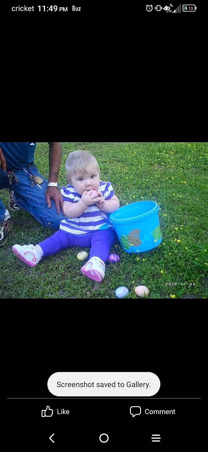 Harmony is registered to the contest to win money with this photo: baby, baby_toddler_clothing, child, display_device, electric_blue, font, fun, grass, happy, lawn, leisure, people_in_nature, person, photo_caption, plant, play, recreation, shorts, sitting, t_shirt