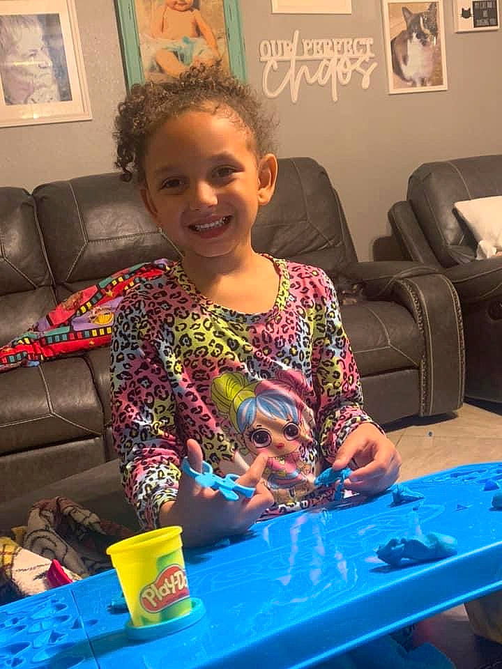 Ktianna joined the competition — help win amazing prizes! blue, chair, child, couch, electronic_device, event, fun, furniture, hairstyle, happy, indoor_games_and_sports, joy, leisure, person, picture_frame, recreation, room, sitting, smile, t_shirt