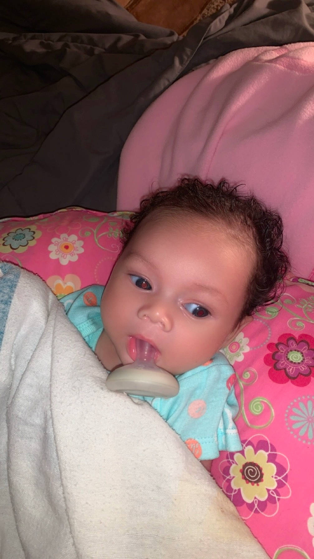 Asiyah is registered to the contest to win money with this photo: baby, baby_toddler_clothing, bedding, bedtime, cheek, child, comfort, eyelash, happy, iris, linens, lip, magenta, nose, pattern, person, pink, sitting, skin, textile