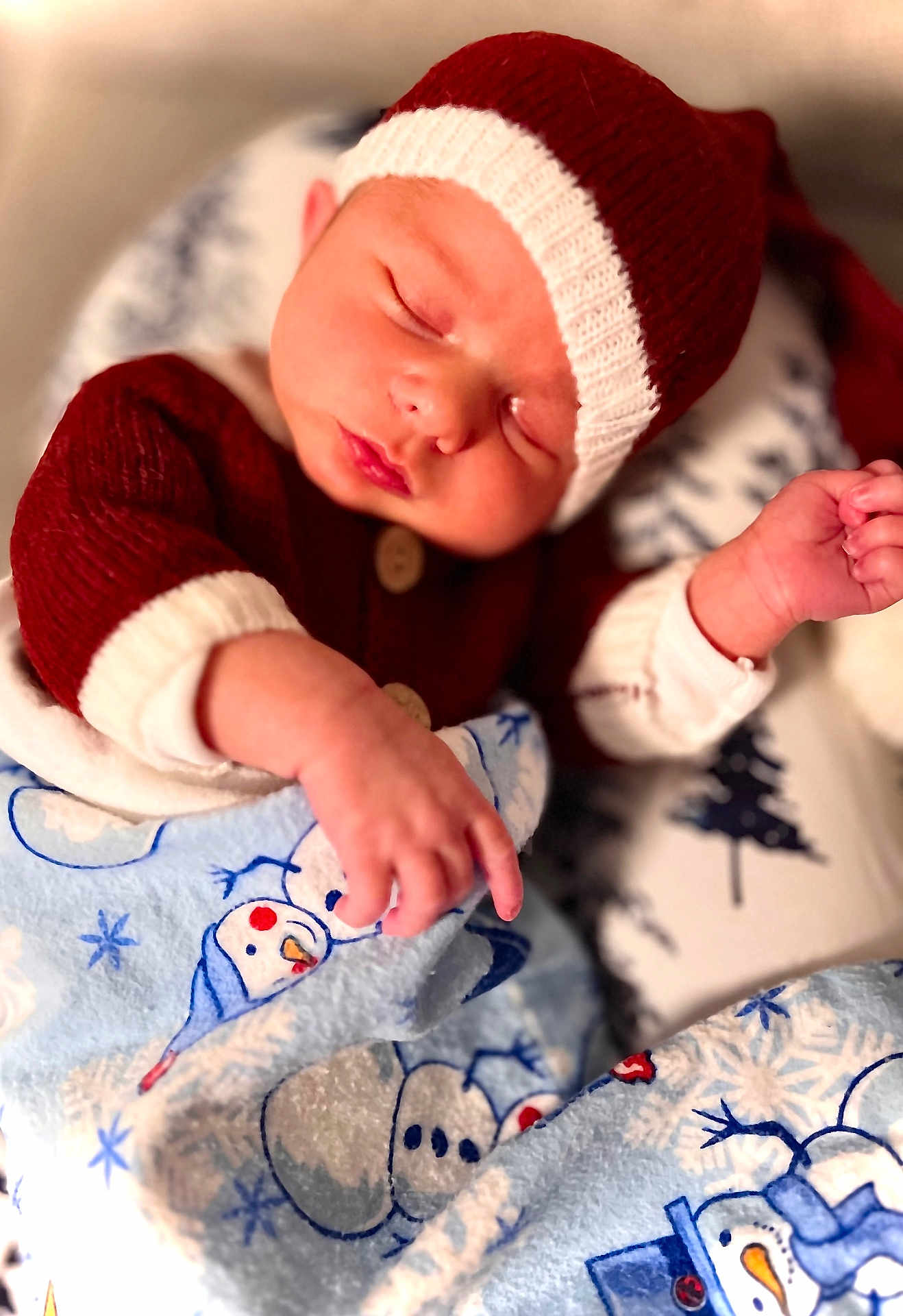 Kaymen is registered to the contest to win money with this photo: baby, newborn, sleeping, knit_hat, red_sweater, blanket, snowman_pattern, cozy, indoors, infant, peaceful, cute, soft, warm, child, portrait, holiday, resting, wrapped, sleep