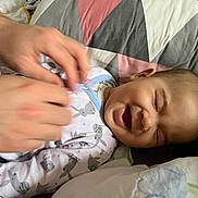 Lysandre participe au concours pour gagner de l'argent avec cette photo : baby, hands, pajamas, laughing, smiling, bed, blanket, quilt, person, infant, cute, sleepwear, child, happy, face, closeup, comfort, indoor, family, care