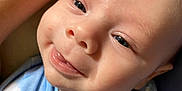 Anthony is registered to the contest to win money with this photo: baby, smiling, tongue_out, blue_clothing, nike_logo, tattoo, butterfly_tattoo, close_up, infant, face, skin, human, cute, child, apparel, sleeve, expression, person, portrait, young
