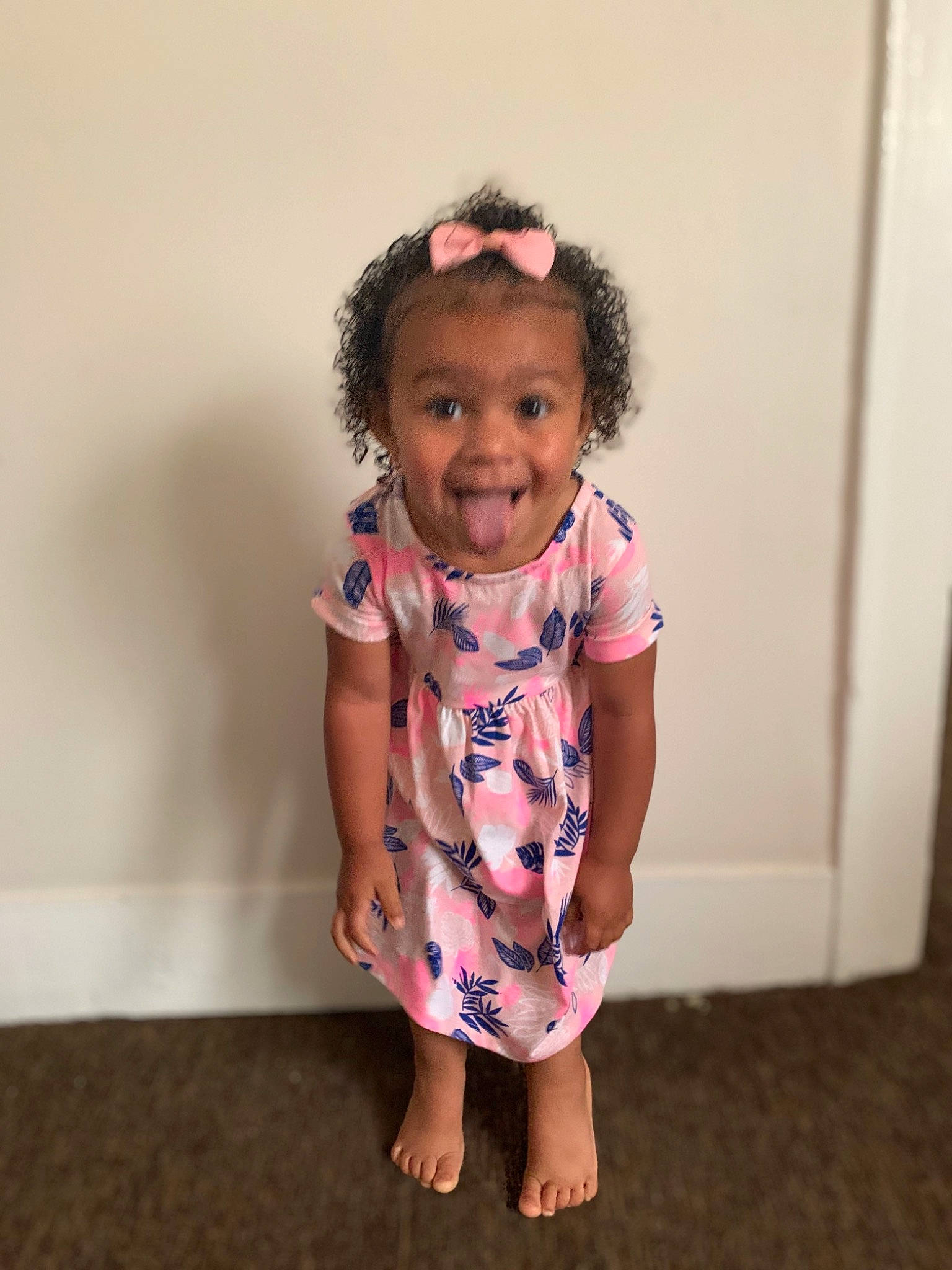 Ella joined the competition — help win amazing prizes! baby, baby_toddler_clothing, cheek, child, dress, face, fun, hairstyle, head, joint, pattern, person, pink, play, shoulder, skin, smile, standing, t_shirt, toddler