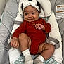 Lavender joined the competition — help win amazing prizes! baby, infant, child, headband, bow, socks, red_clothing, baby_seat, cushion, smile, happy, indoors, soft_furniture, cute, portrait, young_child, baby_girl, playful, comfortable, seated