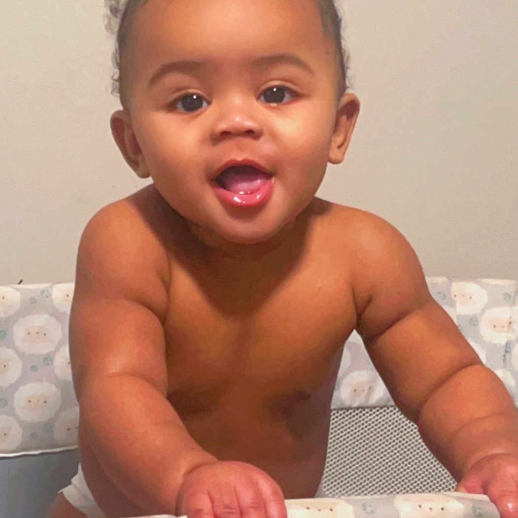 Qeywaun joined the competition — help win amazing prizes! baby, bare_chest, child, curly_hair, cute, eyes, fabric, face, furniture, hand, happy, indoors, infant, mouth, pattern, person, playpen, skin, smiling, young