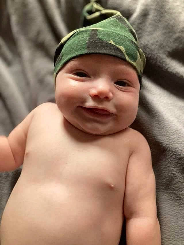 Drake is registered to the contest to win money with this photo: arm, baby, cap, cheek, chest, eye, eyebrow, face, flash_photography, forehead, happy, head, headwear, lip, mouth, neck, nose, person, skin, smile