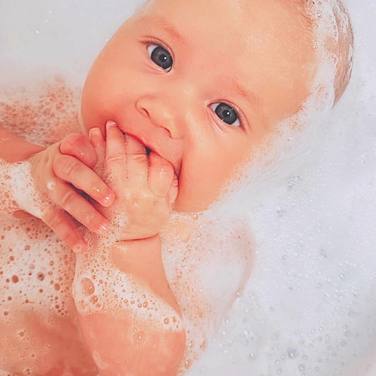 Sophia is registered to the contest to win money with this photo: baby, bath, bathtub, bubbles, child, cleaning, cute, eyes, face, foam, hands, infant, playful, portrait, relaxation, skin, soapy, water, wet, young