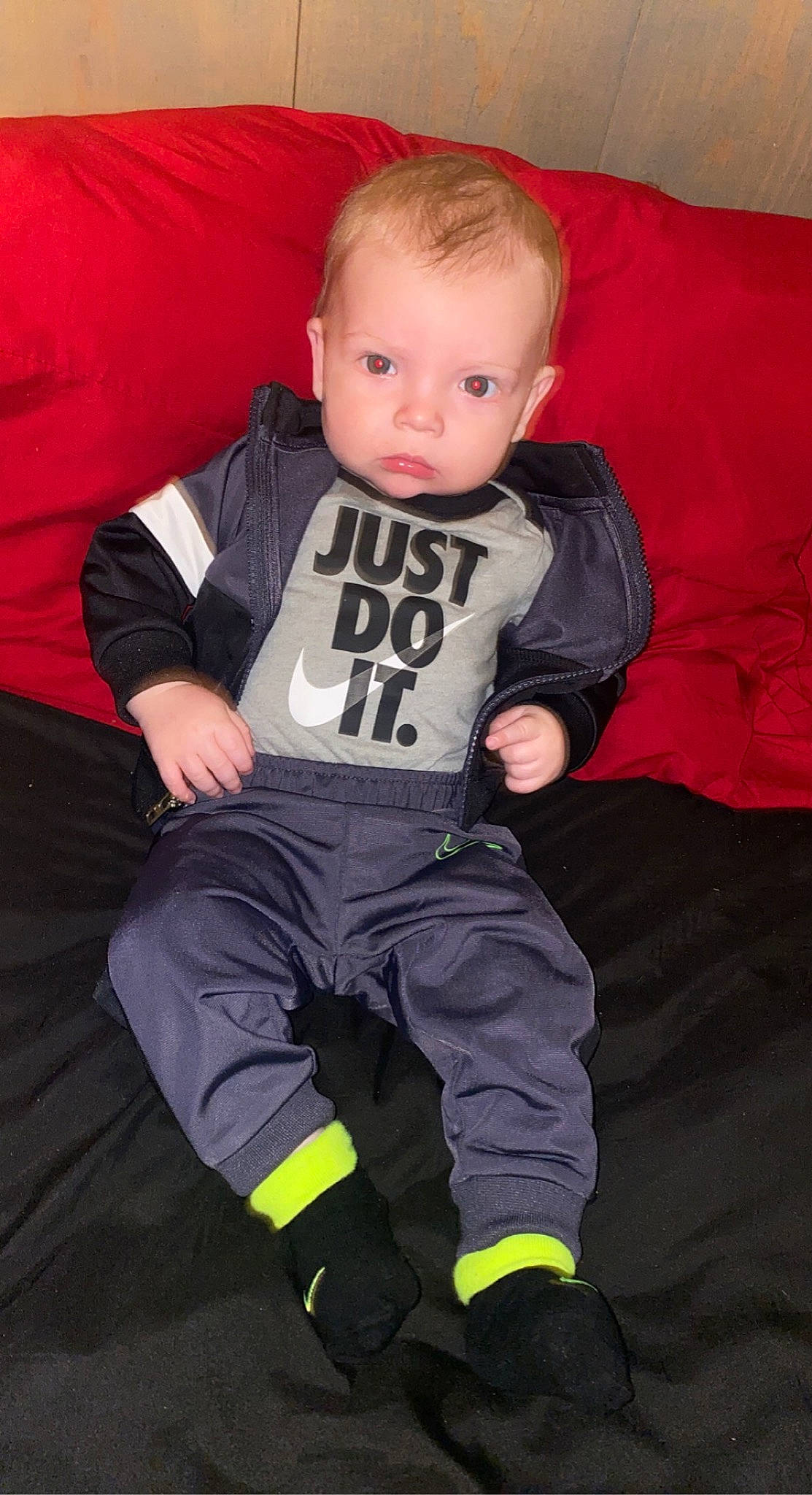 Cooper is registered to the contest to win money with this photo: baby, baby_toddler_clothing, chair, child, comfort, cool, couch, flash_photography, fun, hairstyle, magenta, orange, person, personal_protective_equipment, sitting, sleeve, sock, sportswear, standing, t_shirt