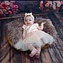 Khatalia a rejoint le concours — aidez-le/la à gagner de superbes lots ! baby, infant, girl, dress, headband, basket, cushion, floor, wooden_floor, floral_backdrop, portrait, cute, soft_lighting, indoors, smiling, child, tulle_skirt, pink, relaxed, photography
