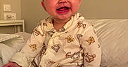 Isla joined the competition — help win amazing prizes! baby, child, pajamas, bed, smile, happy, infant, cute, indoors, face, person, foot, hand, sleepwear, animal_print, crawling, cozy, portrait, skin, young