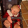 baby, barefoot, blonde_hair, child, cozy, cute, harness, indoor, infant, lace_collar, peaceful, pink_bow, portrait, raised_foot, red_outfit, seated, sleeping, stroller, tiled_floor, wheelchair_like_stroller
