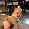 Isla is registered to the contest to win money with this photo: baby, blonde_hair, bow, candid_photo, carpet, casual_clothing, child, crawling, feet, floor, furniture, hands, happy, home, indoor, infant, playroom, portrait, sitting, smiling