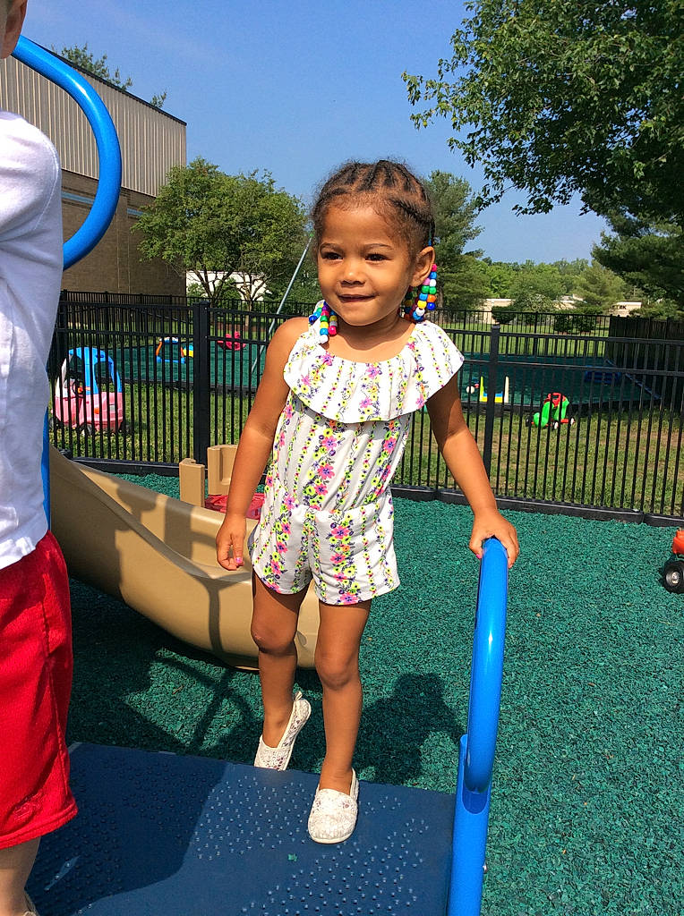 Nadia is registered to the contest to win money with this photo: child, city, electric_blue, event, fun, grass, happy, human_leg, joy, leaf, leg, leisure, outdoor_play_equipment, outdoor_recreation, person, playground, recreation, shorts, sky, smile