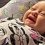 Allison is registered to the contest to win money with this photo: apparel, baby, butterfly, cartoon, child, closeup, clothing, cute, fabric, face, happy, infant, lying_down, pattern, person, pillow, portrait, skin, smiling, soft_lighting