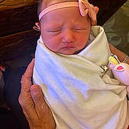 Allison is registered to the contest to win money with this photo: baby, blanket, bow, carving, clothing, cute, fingers, hand, headband, indoors, infant, newborn, peaceful, person, portrait, skin, sleeping, soft, wood, wrapped