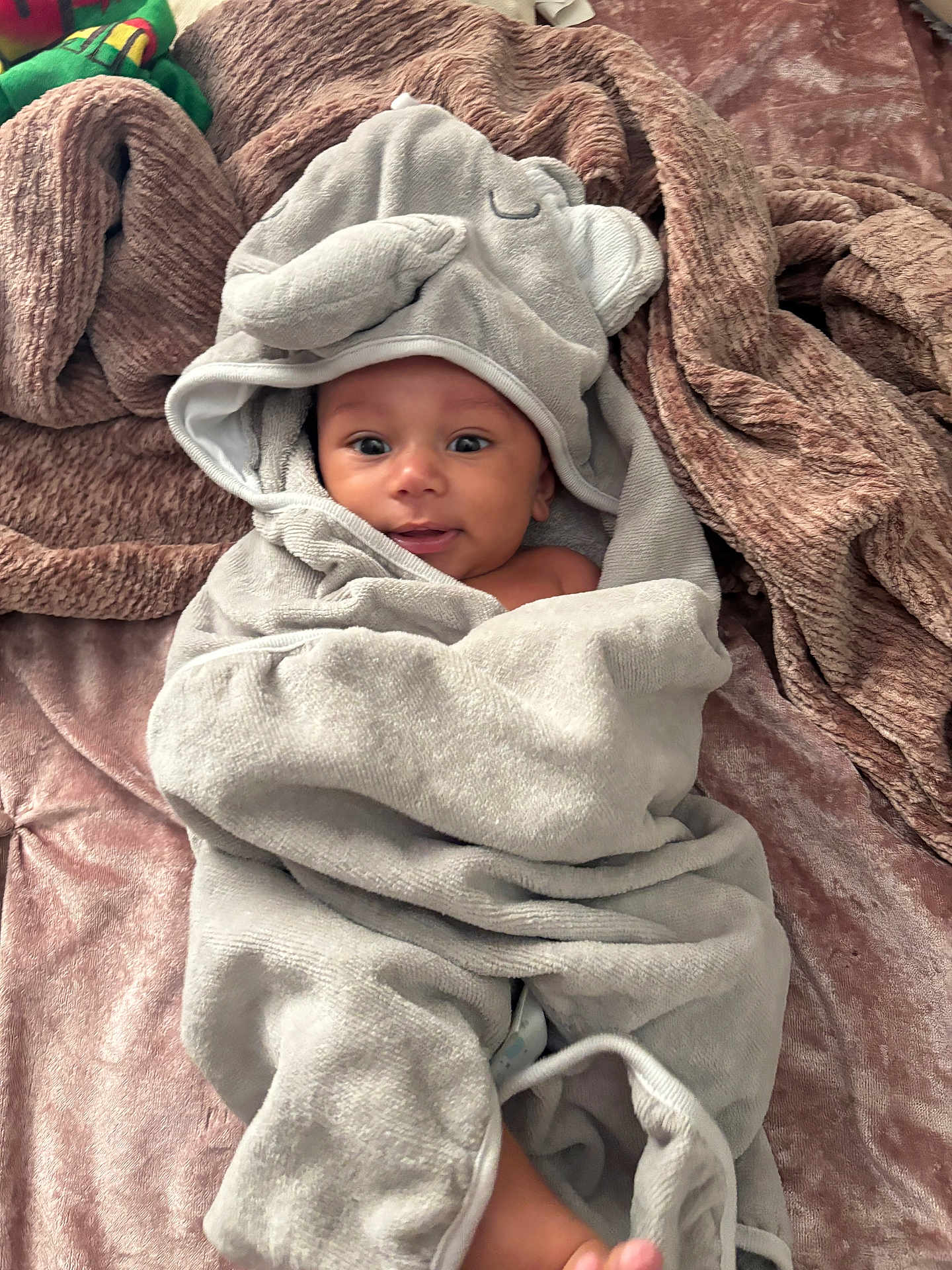 Chosen joined the competition — help win amazing prizes! baby, towel, hood, elephant, blanket, soft, texture, cute, infant, smile, face, eyes, lying_down, wrapped, cozy, indoors, person, child, happy, plush