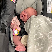 Lainie joined the competition — help win amazing prizes! baby, infant, car_seat, blanket, pacifier, sleeping, straps, cozy, cloud_pattern, cute, child, indoor, soft_texture, pink_clothing, foot, head, face, peaceful, resting, safety