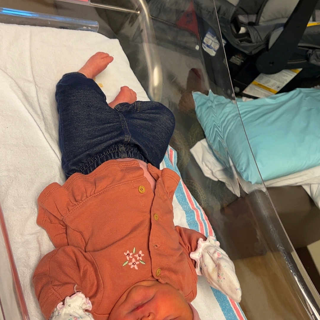 Lainie joined the competition — help win amazing prizes! newborn, baby, hospital, bassinet, sleeping, clothing, mittens, headband, blanket, infant, person, resting, pink, blue, towel, carseat, baby_care, indoor, cute, peaceful