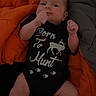 Lainie joined the competition — help win amazing prizes! baby, infant, onesie, clothing, blanket, orange, gray, deer, text, lying, soft, cute, fist, looking, portrait, indoor, newborn, person, child, sleepwear