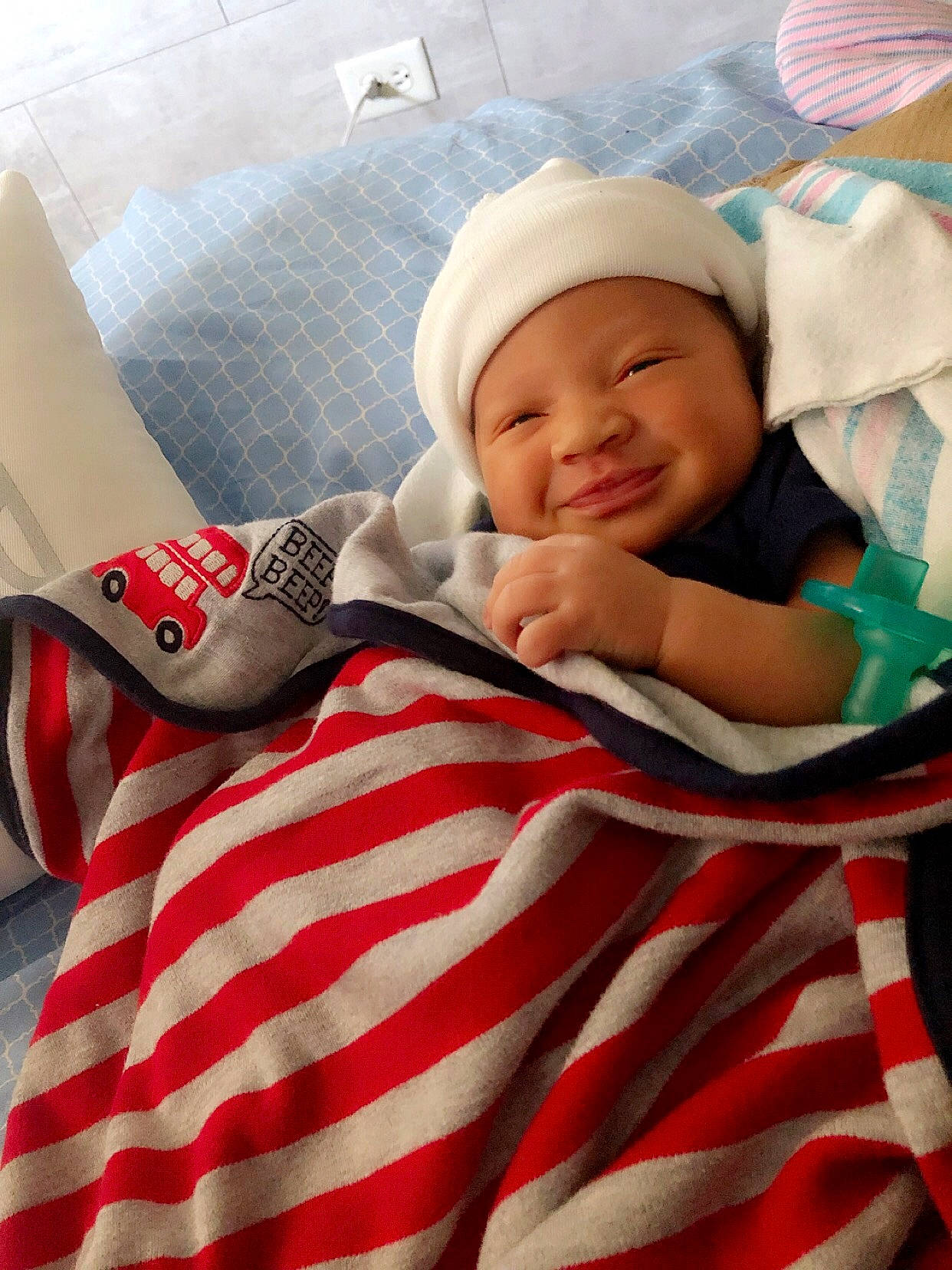 Cartier is registered to the contest to win money with this photo: baby, cheek, child, headwear, joy, linens, person, textile, toddler