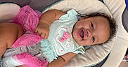 Kollyns is registered to the contest to win money with this photo: baby, buckle, car_seat, chubby_cheeks, close_up, curly_hair, cushion, fabric, hand, happy, harness, indoor, infant, mint_clothing, pink_tutu, playful, portrait, seat, smiling, toy