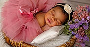 Ja'Sandra joined the competition — help win amazing prizes! newborn, baby, sleeping, pink_tutu, headband, flower, pillow, wicker_basket, fur, purple_flowers, pink_flowers, portrait, cute, infant, resting, soft_texture, decorative, peaceful, indoor, closeup