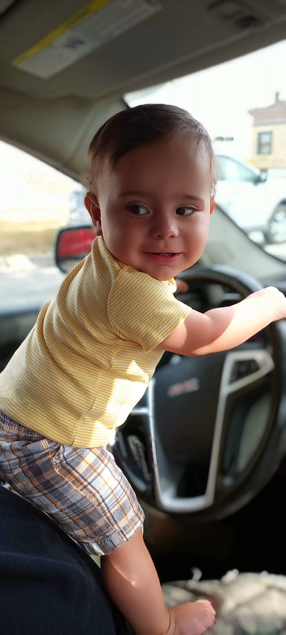 U'Nique is registered to the contest to win money with this photo: auto_part, automotive_design, automotive_exterior, baby, car, child, driving, family_car, joy, luxury_vehicle, person, smile, toddler, vehicle, vehicle_door