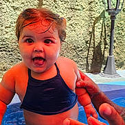Amy Albert Sosa joined the competition — help win amazing prizes! toddler, child, pool, water, splashing, smiling, happy, outdoor, summer, swimwear, hand, adult, wall, lamp_post, sunlight, reflection, skin, wet_hair, play, fun