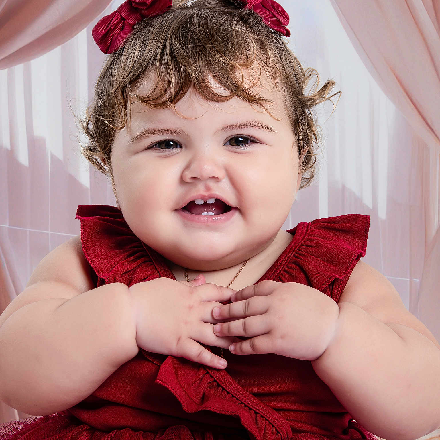 Amy Albert Sosa is registered to the contest to win money with this photo: baby, child, dress, red_dress, bows, curly_hair, smile, happy, portrait, hands, cute, indoors, curtains, pink_curtains, toddler, face, chubby_cheeks, cute_expression, person, young_child