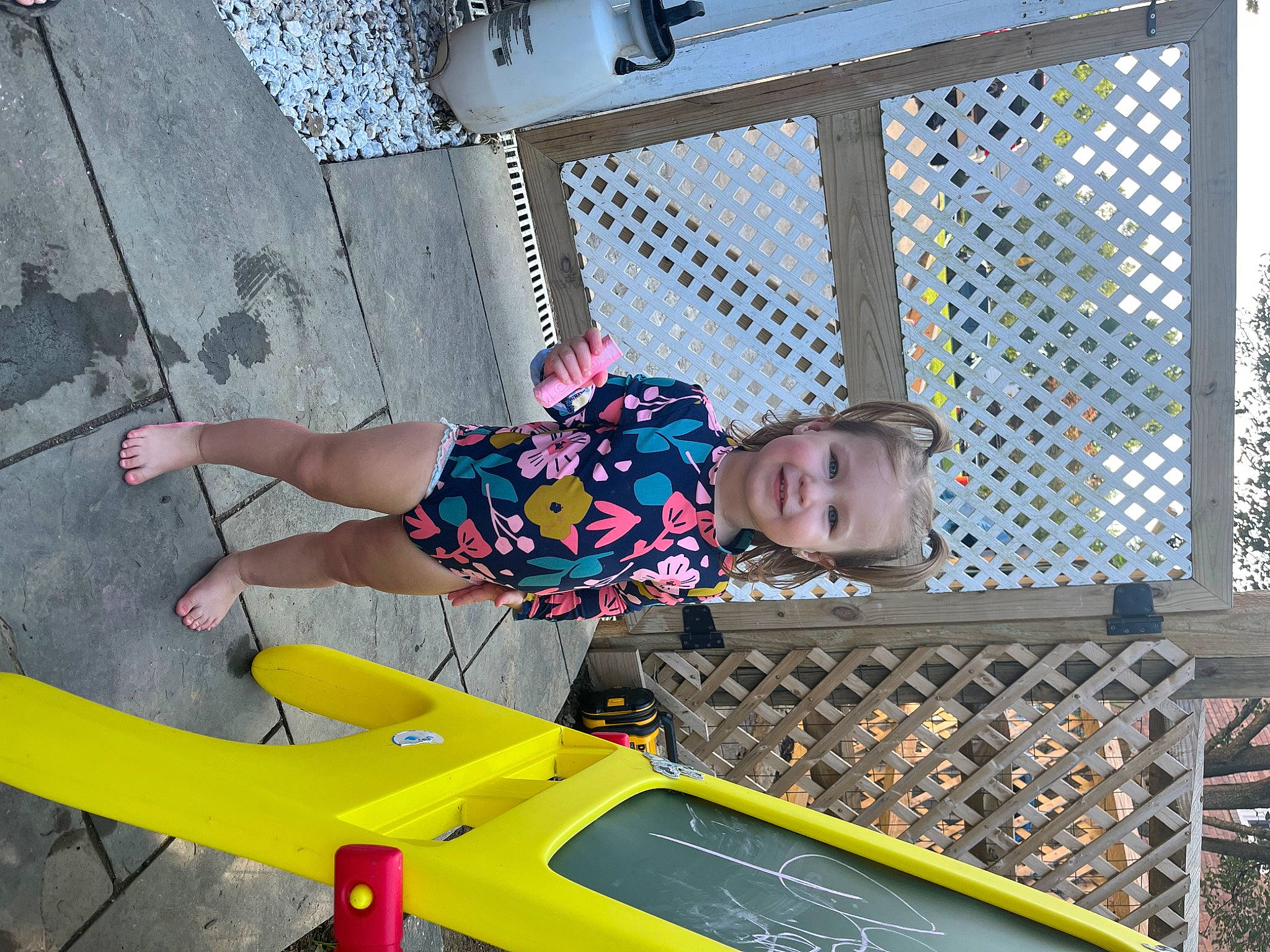 Briella is registered to the contest to win money with this photo: baby_toddler_clothing, child, city, fence, fun, human_leg, joy, leisure, pattern, person, recreation, smile, thigh, toddler, vacation