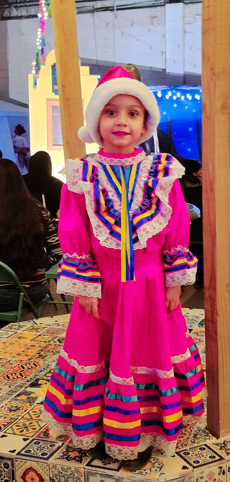 Isabella Estrada is registered to the contest to win money with this photo: chair, child, costume, costume_hat, electric_blue, event, fashion, fashion_design, fun, hat, headwear, joy, magenta, people, person, pink, purple, smile, toddler, tradition