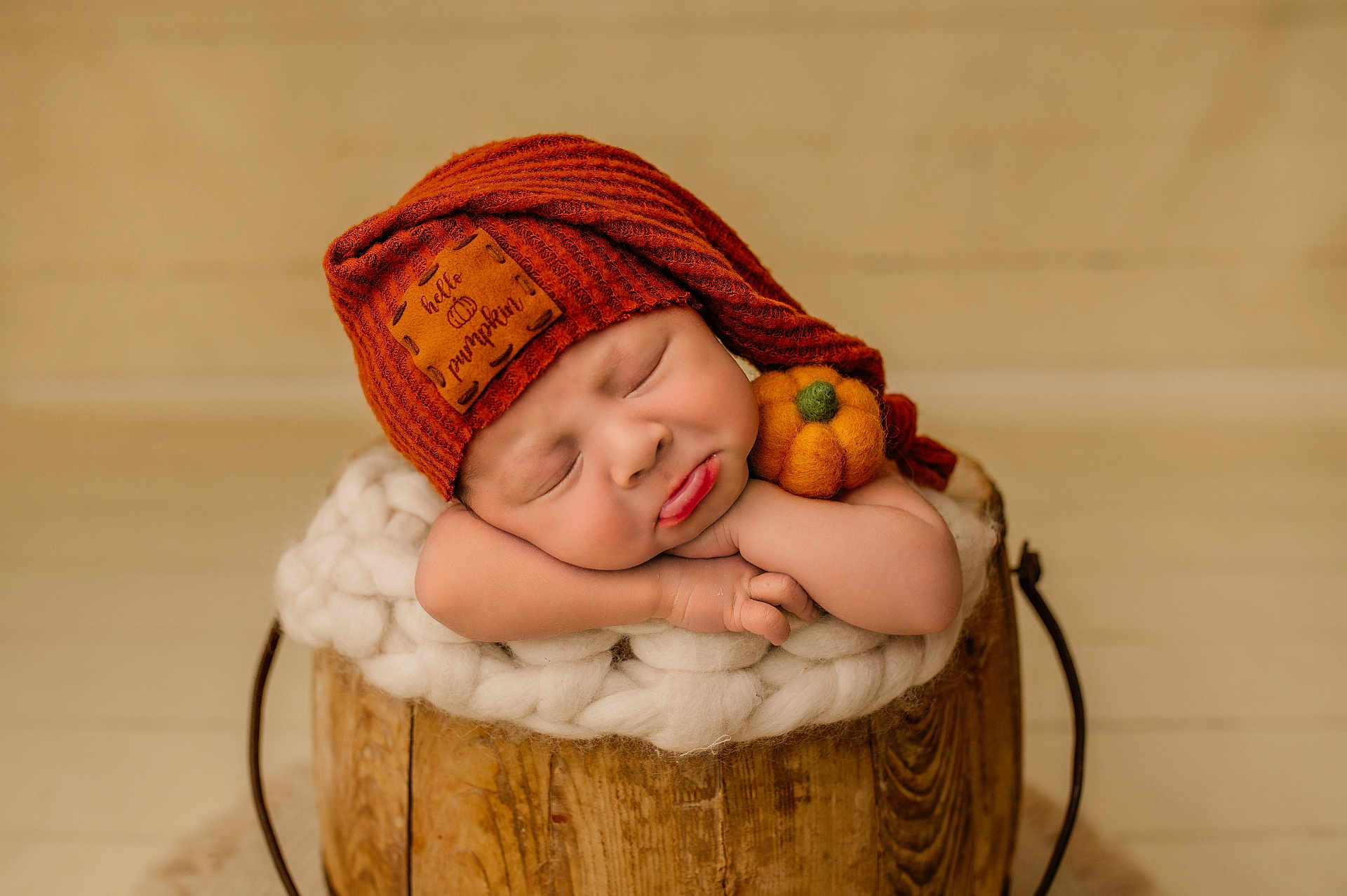 Cooper is registered to the contest to win money with this photo: baby, sleeping, orange_hat, knit_hat, pumpkin_patch, felt_pumpkin, wooden_bucket, fluffy_blanket, resting, cute, infant, portrait, cozy, soft_texture, newborn, peaceful, child, indoors, warm_colors, adorable