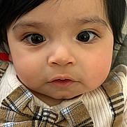 Dante is registered to the contest to win money with this photo: apparel, baby, bow_tie, child, close_up, clothing, curly_hair, cute, expression, eyes, face, fashion, head, indoor, infant, person, plaid, portrait, skin, young