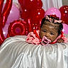 baby, pacifier, pink_bows, red_balloons, pink_balloons, love_balloons, silky_fabric, infant, child, portrait, celebration, cute, lying_down, decorations, indoor, closeup, face, expression, holiday, festive