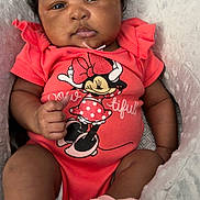 Kalani joined the competition — help win amazing prizes! baby, infant, child, onesie, pink_socks, minnie_mouse, cartoon_character, soft_blanket, cozy, portrait, indoor, curly_hair, cute, relaxed, seated, person, skin, hand, face, expression