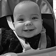 Lylio participe au concours pour gagner de l'argent avec cette photo : baby, baby_toys, black_and_white, child, childcare, closeup, cute, face, happy, high_chair, indoor, infant, person, playtime, portrait, seat, seatbelt, smile, toy, young