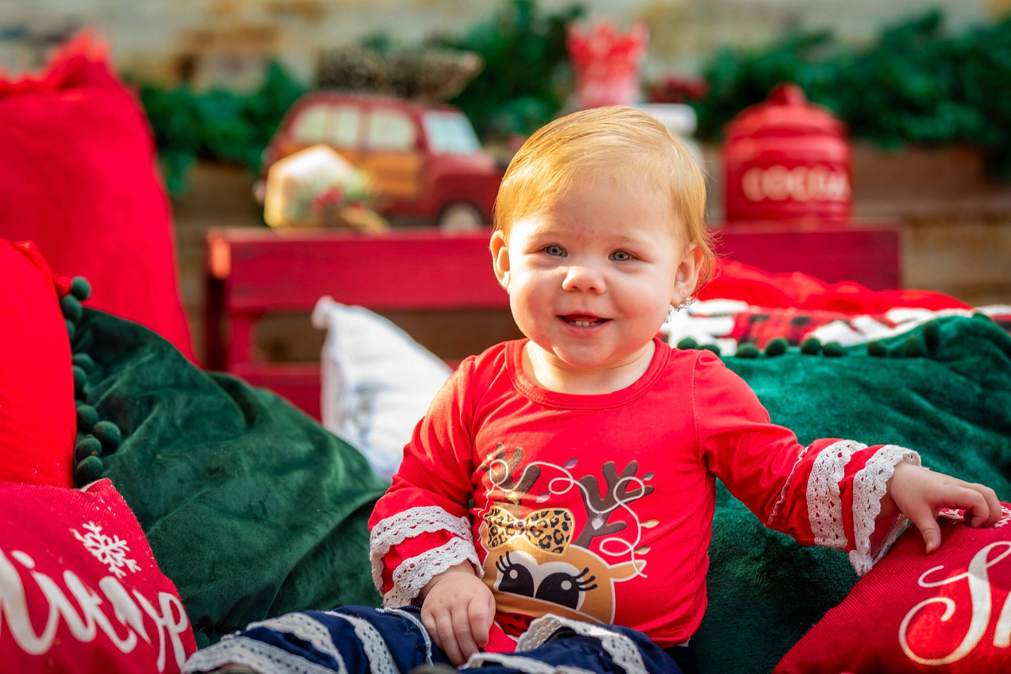 Macie is registered to the contest to win money with this photo: baby, baby_toddler_clothing, child, christmas, christmas_eve, event, facial_expression, fun, grass, happy, holiday, joy, leisure, people, person, recreation, red, sitting, smile, snapshot