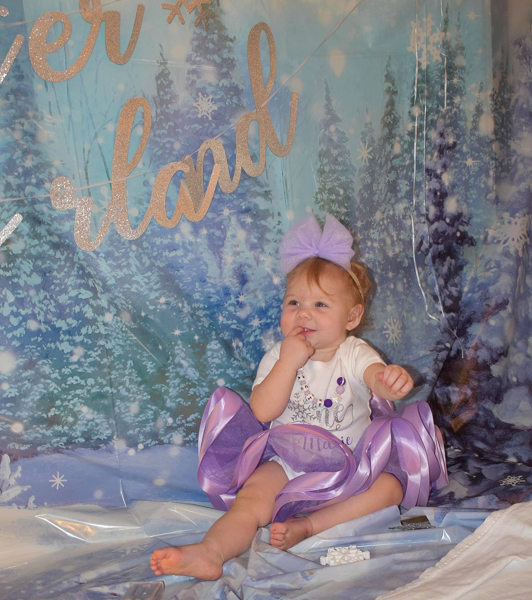 Macie joined the competition — help win amazing prizes! baby_toddler_clothing, beauty, child, christmas_ornament, costume_hat, event, font, fun, happy, hat, nature, people_in_nature, person, pink, purple, sitting, sun_hat, toddler, tree, winter
