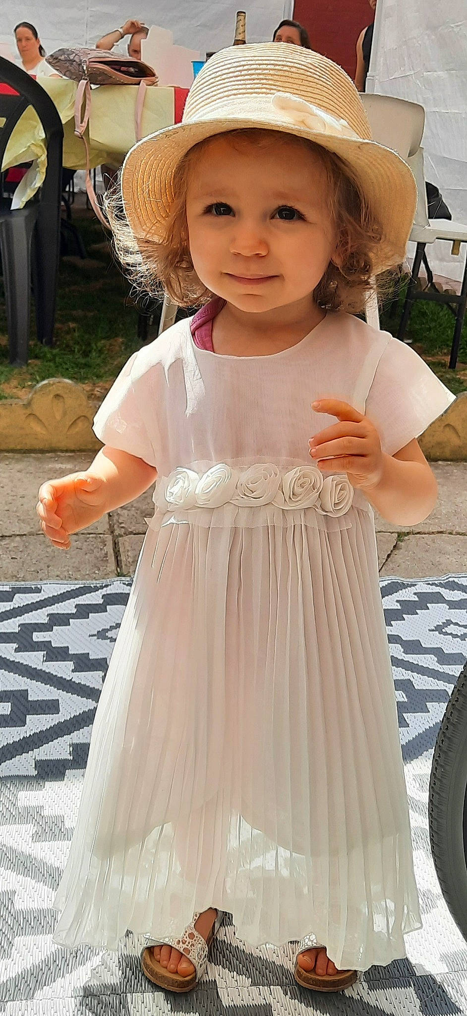 Lyana participe au concours pour gagner de l'argent avec cette photo : baby_toddler_clothing, bridal_clothing, bridal_party_dress, chair, clothing, day_dress, dress, embellishment, fashion, happy, hat, headwear, people, person, photograph, pink, skin, sleeve, summer, toddler